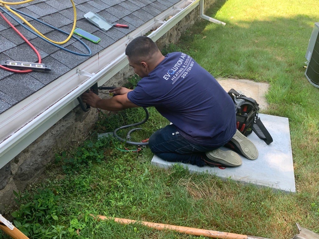 A man working on the gutter of his home.